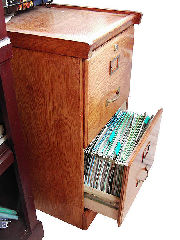 A wooden Filing Cabinet with drawer open