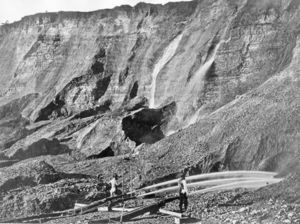 Gold miners excavate a gold-bearing bluff with jets of water at a placer mine in Dutch Flat, California sometime between 1857 and 1870.