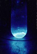 Quartz vial (9 mm diameter) containing ~300 micrograms of solid 253Es. The illumination produced is a result of the intense radiation from 253Es.