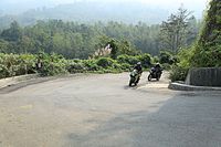 Two motorcycles rounding a curve