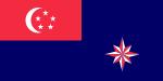 A red rectangle at the top left corner of the flag, charged with a white crescent and five white stars arranged in a pentagon. The rest of the flag is coloured blue. At the bottom right part of the flag is an eight pointed star that is alternating red and white.