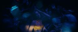 Dua Lipa dancing in a crowded nightclub.