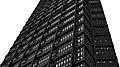 A black-brown steel building rises upwards.