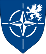 Coat of arms of the Joint Force Training Centre.svg