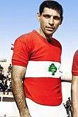 Joseph Abou Murad wearing a red Lebanese jersey with a green cedar in the center inside a white horizontal band