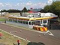 The start/finish straight with a pit garage inspired by a Shell fuel station