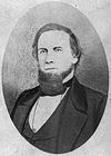 Sepia print shows a bearded man in a civilian coat and vest.