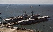 USS Boxer (LPH-4) right, moored across from the aircraft carrier USS America (CVA-66) at Pier No. 11, Naval Operating Base Norfolk, 1 October 1969.