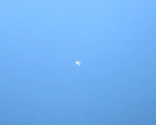 Two bright white dots almost touching on a blue background