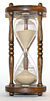The flow of sand in an hourglass can be used to measure the passage of time. It also concretely represents the present as being between the past and the future.