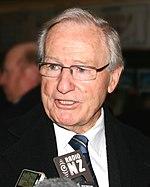 Jim Bolger at press conference retouched.jpg