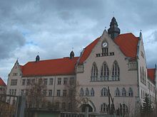 A large building with many windows, the architecture is of the Founder Epoch.