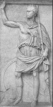 A monochrome relief stele depicting a man in classical Greek clothing raising one arm