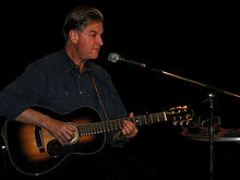 Geoff Muldaur performing with his guitar