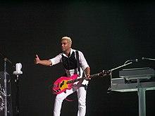 A color photograph of British-American bassist Tony Kanal performing live in 2009.