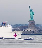 USNS Comfort passing by the Statue of Liberty
