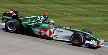 Webber driving his green Jaguar R5 at the 2004 United States Grand Prix at Indianapolis Motor Speedway