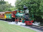 A green steam locomotive with a 4-6-0 wheel arrangement (four leading wheels, six driving wheels, and no trailing wheels) and its tender