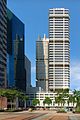 Distant view of a box-like building with many black ridges; a similar-looking building is located directly behind it.