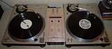Two vinyl turntables and a small mixer