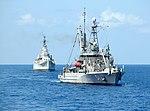 USNS Grasp (T-ARS-51) tows USS Des Moines (CA-134) to the scrapyard, in October 2006.jpg
