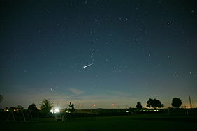 Night sky with a very bright satellite flare