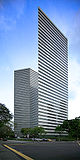 Ground-level view of a sharp, narrow corner on a building with a striped metal and glass facade