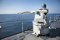 US Navy 111231-N-KS651-967 A Mk 38 MOD 2 25mm machine gun system aboard the amphibious dock landing ship USS Pearl Harbor (LSD 52) ejects casings d.jpg