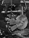 milling machine - machine tool in which metal that is secured to a carriage is fed against rotating cutters that shape it