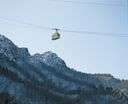 aerial tramway - a conveyance that transports passengers or freight in carriers suspended from cables and supported by a series of towers