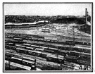 railyard - an area having a network of railway tracks and sidings for storage and maintenance of cars and engines