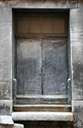 back door - an entrance at the rear of a building
