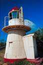 Pharos - a tower with a light that gives warning of shoals to passing ships