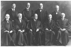 The 1919 Schenck case marked the first time the Court heard a First Amendment challenge to a federal law on free speech grounds. The Court was comprised of the following justices: (standing, l-r) Brandeis, Pitney, McReynolds, Clarke, (seated, l-r) Day, McKenna, White, Holmes, Van Devanter. U.S. SUPREME COURT