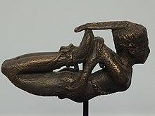 Bronze figurine of a bound man.