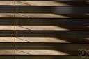 venetian blind - a window blind made of horizontal strips that overlap when closed