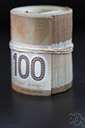 bankroll - a roll of currency notes (often taken as the resources of a person or business etc.)
