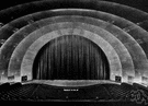 apron - the part of a modern theater stage between the curtain and the orchestra (i.e., in front of the curtain)