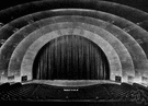proscenium - the part of a modern theater stage between the curtain and the orchestra (i.e., in front of the curtain)