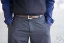 belt - a band to tie or buckle around the body (usually at the waist)