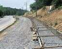 bed - a foundation of earth or rock supporting a road or railroad track