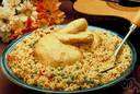 biryani - an Indian dish made with highly seasoned rice and meat or fish or vegetables