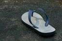 thong - a backless sandal held to the foot by a thong between the big toe and the second toe